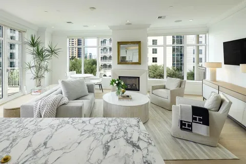 a living room with furniture large window and flat screen tv