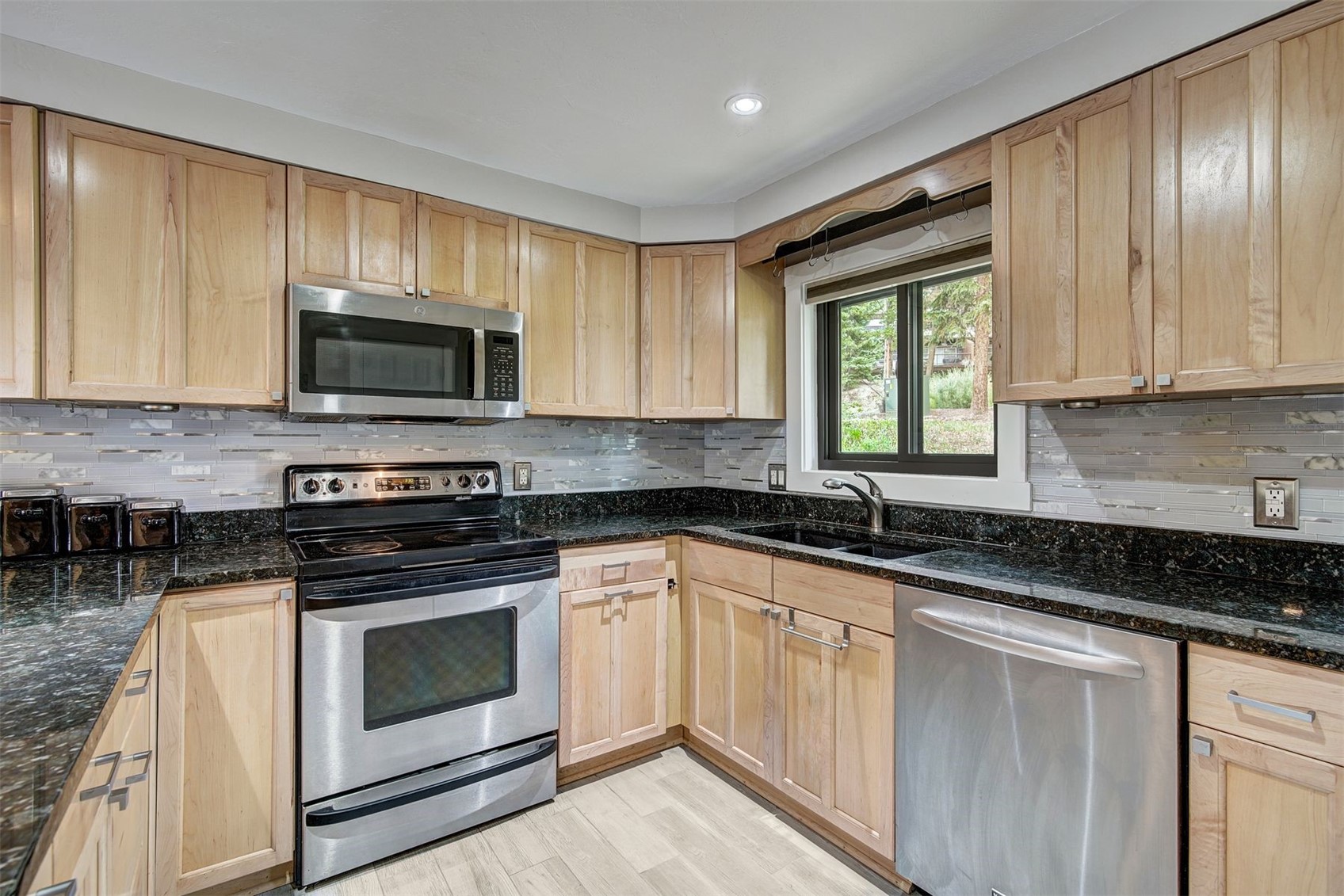 52 Club House Road, Unit 44 Breckenridge, CO 80424 - Photo 2 of 28 a kitchen with granite countertop a stove top oven sink and cabinets