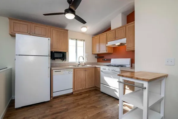 a kitchen with white cabinets and white appliances