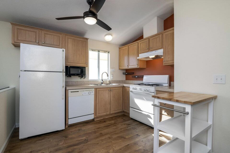 80 Zaca Street, Unit SPC 15 Buellton, CA 93427 - Photo 4 of 17 a kitchen with white cabinets and white appliances