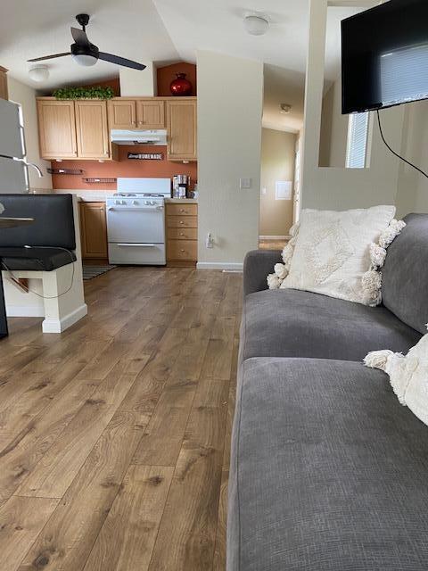 80 Zaca Street, Unit SPC 15 Buellton, CA 93427 - Photo 5 of 17 a living room with couches and kitchen view with wooden floor