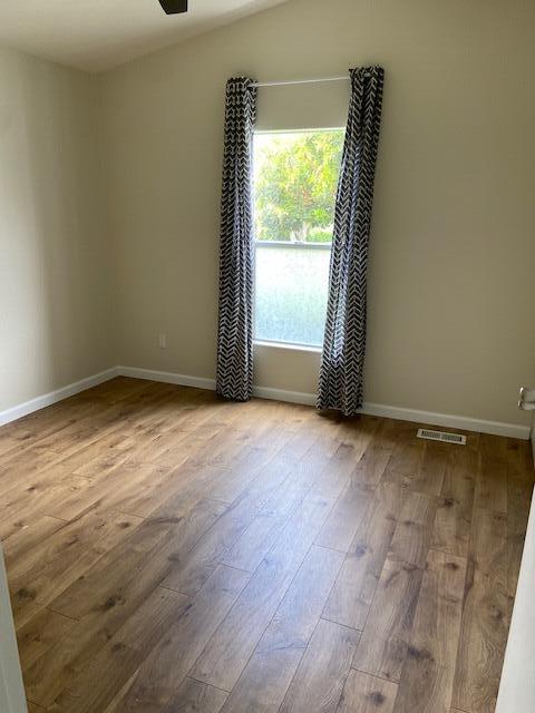 80 Zaca Street, Unit SPC 15 Buellton, CA 93427 - Photo 6 of 17 an empty room with wooden floor and windows
