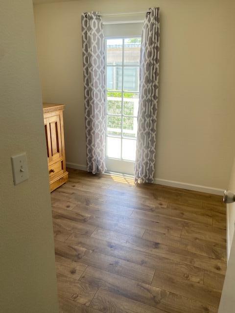 80 Zaca Street, Unit SPC 15 Buellton, CA 93427 - Photo 7 of 17 a view of an empty room with window and hardwood floor