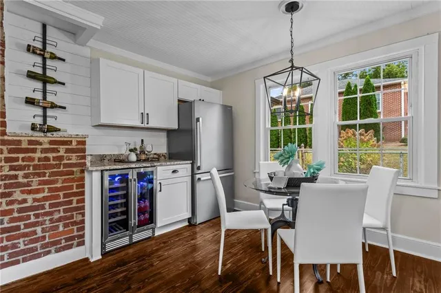a dining room with furniture a chandelier and wooden floor