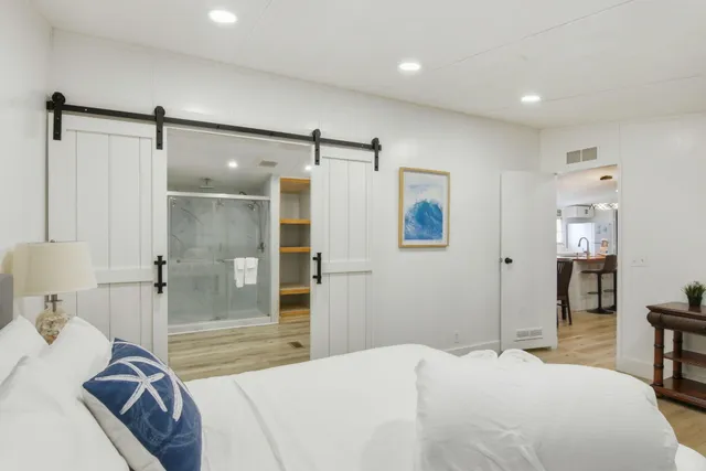 a bedroom with a bed and a shower