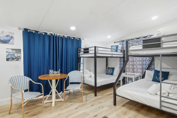 a bedroom with furniture and a mirror
