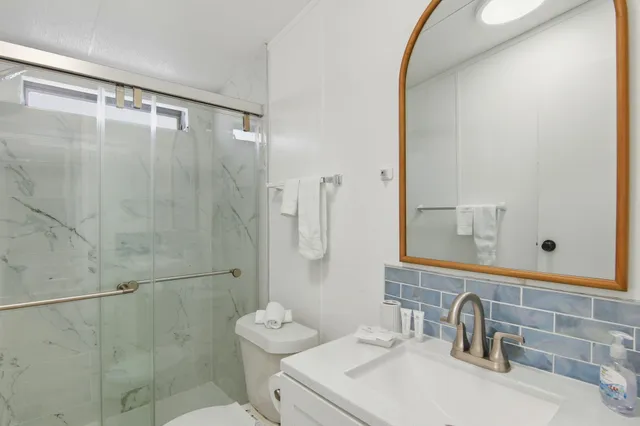 a bathroom with a sink toilet and shower