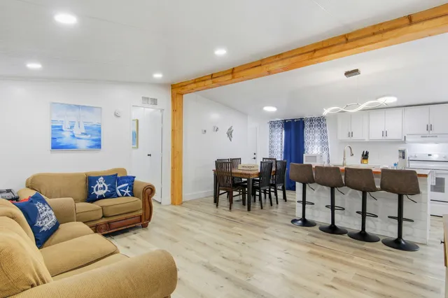 a living room with furniture and kitchen view