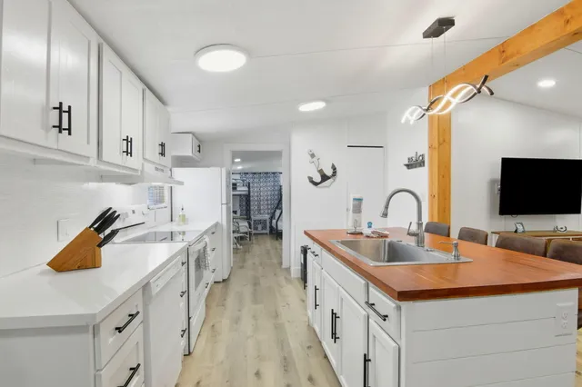 a kitchen with sink and refrigerator