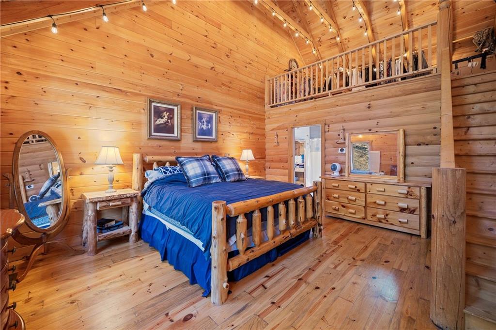 665 Little Refuge Road Waleska, GA 30183 - Photo 23 of 73 a bedroom with a bed next to a window and painting on the wall