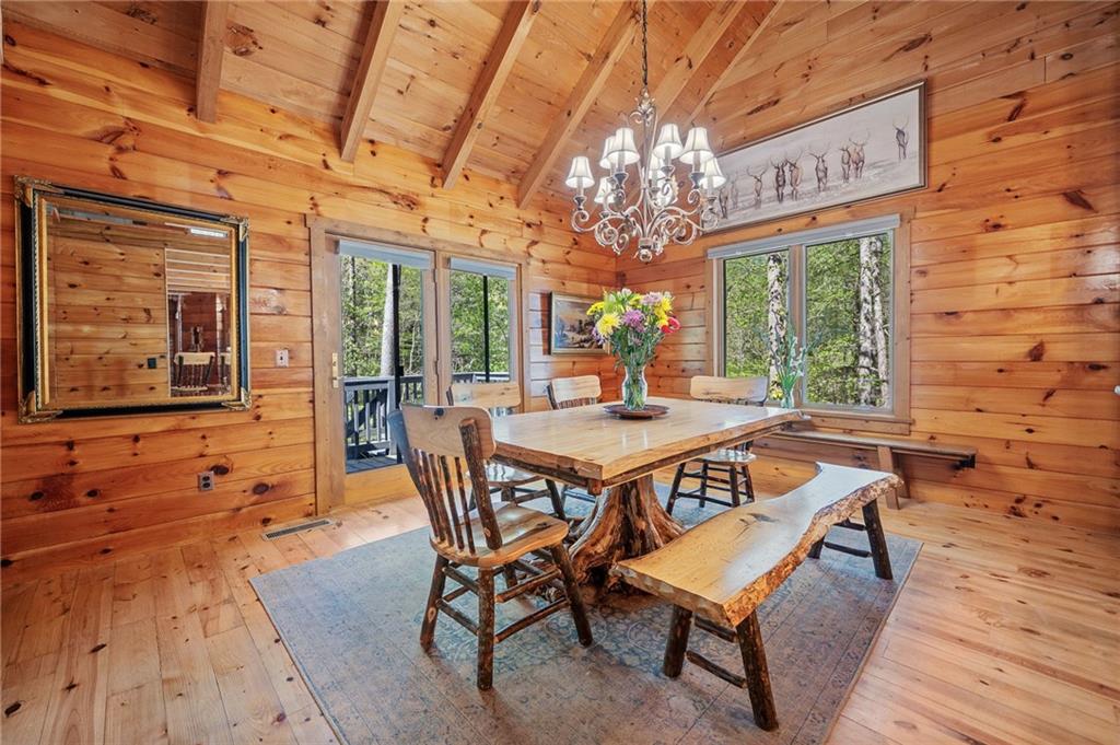 665 Little Refuge Road Waleska, GA 30183 - Photo 34 of 73 a view of a dining room with furniture a chandelier and wooden floor