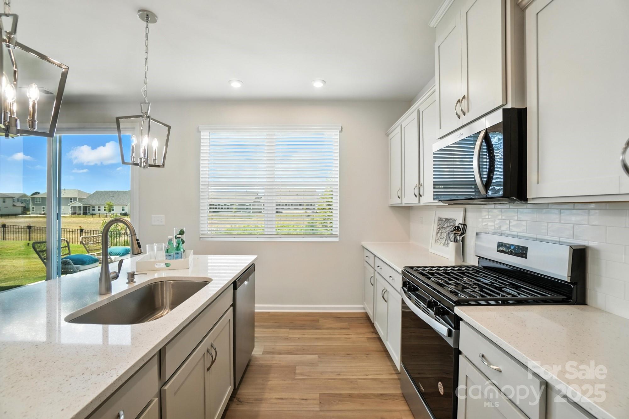 1217 Roscoe Court Monroe, NC 28112 - Photo 15 of 46 a kitchen with stainless steel appliances a sink a stove and oven