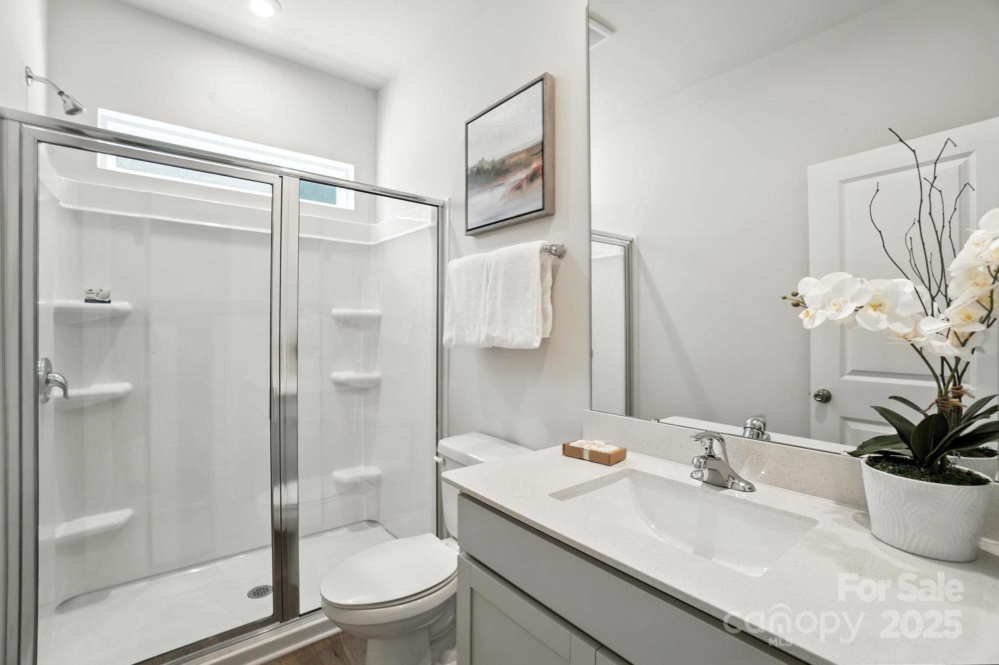 1217 Roscoe Court Monroe, NC 28112 - Photo 22 of 46 a bathroom with a granite countertop sink a toilet and shower
