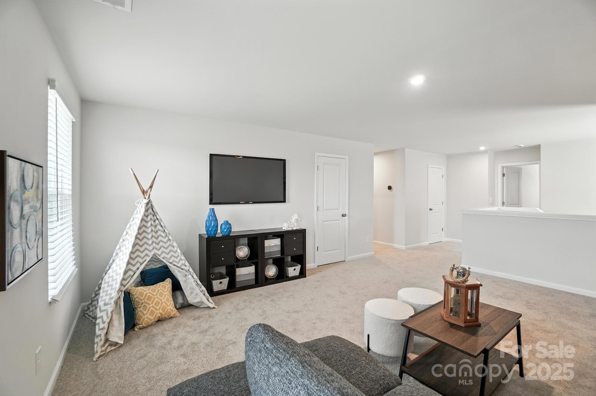1217 Roscoe Court Monroe, NC 28112 - Photo 26 of 46 a living room with furniture and a flat screen tv