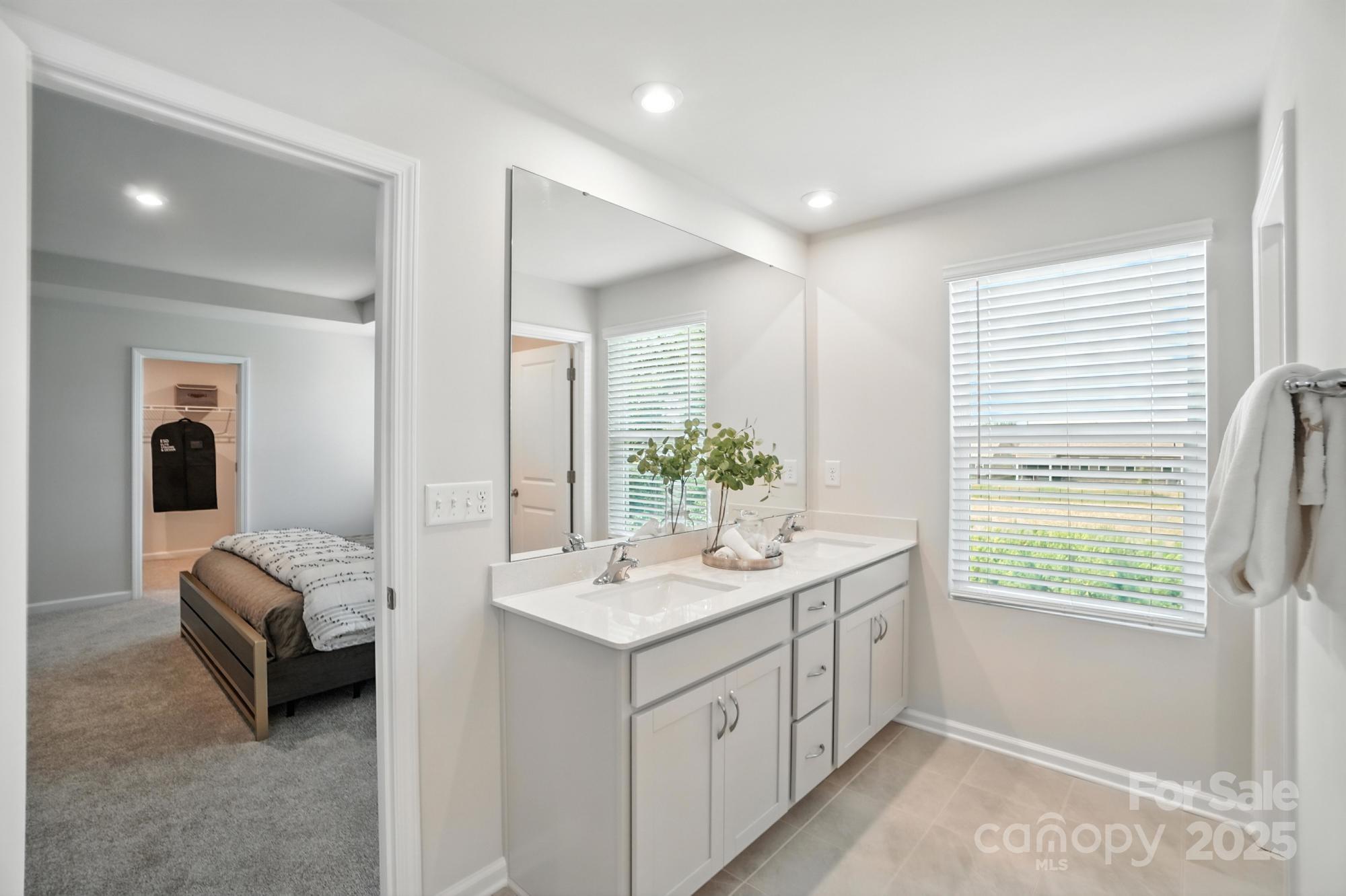 1217 Roscoe Court Monroe, NC 28112 - Photo 33 of 46 a bathroom with a double vanity sink and a window