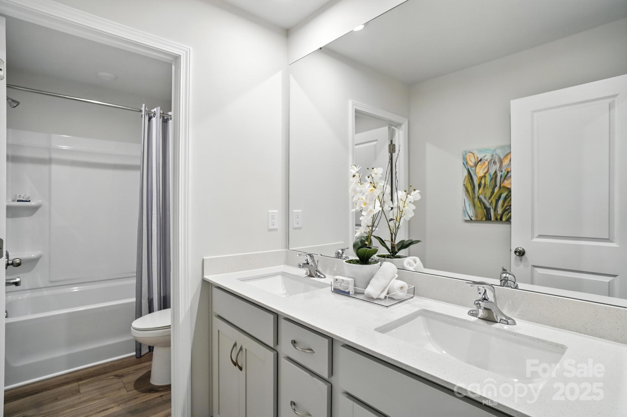 1217 Roscoe Court Monroe, NC 28112 - Photo 40 of 46 a bathroom with a granite countertop toilet a sink and a bathtub