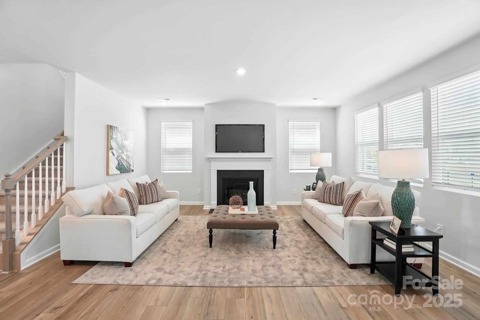1217 Roscoe Court Monroe, NC 28112 - Photo 6 of 46 a living room with furniture and a fireplace