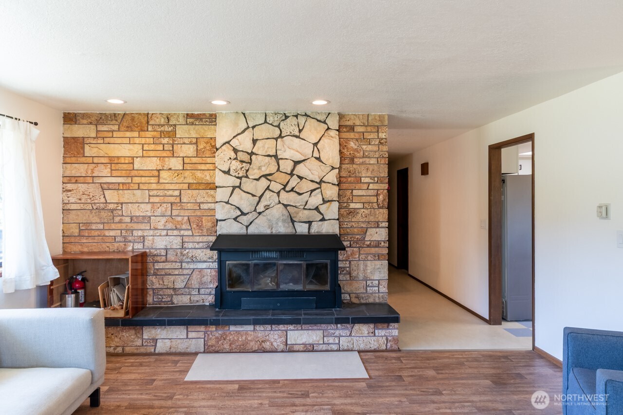63 East Arnette Road Port Angeles, WA 98362 - Photo 12 of 40 a living room with furniture and a fireplace