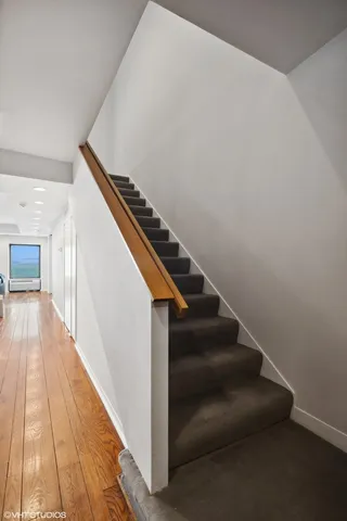 a view of entryway and hall with wooden floor