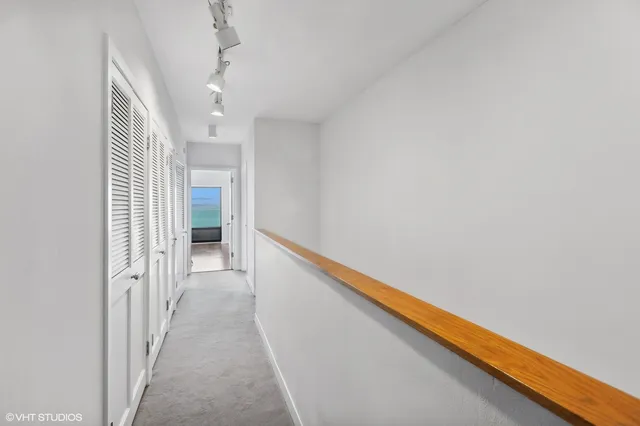 a view of a hallway with stairs