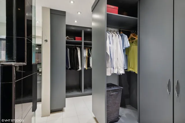 a view of walk in closet with clothes and shoes