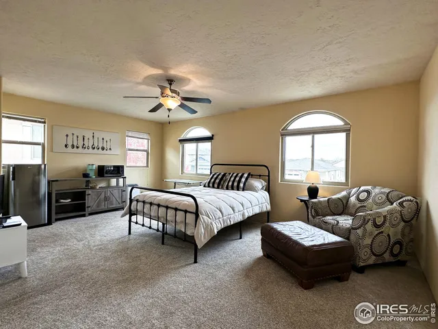 a spacious bedroom with a bed and a couch