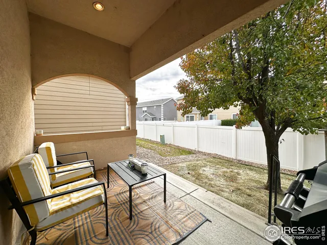 a view of a two chairs in the back yard