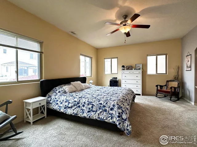 a bedroom with a bed and a couch