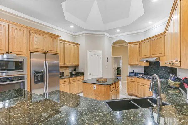 a large kitchen with a table and chairs