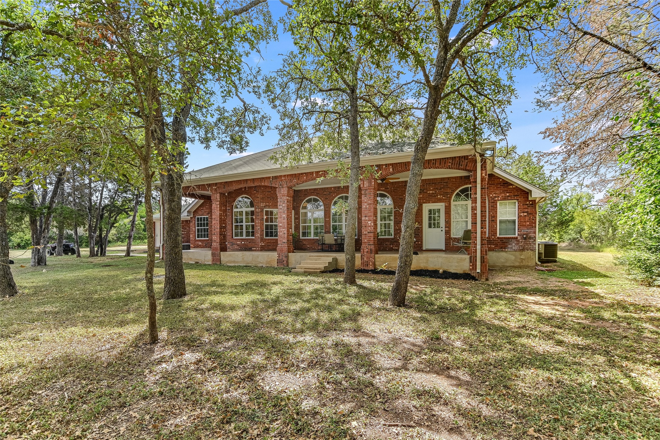 741 Knobbs Road McDade, TX 78650 - Photo 24 of 37 a view of a house with backyard and a tree