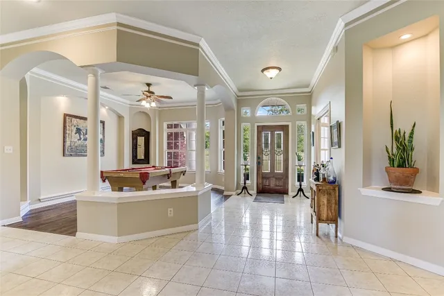 a kitchen with a sink a counter top space and a view of living room