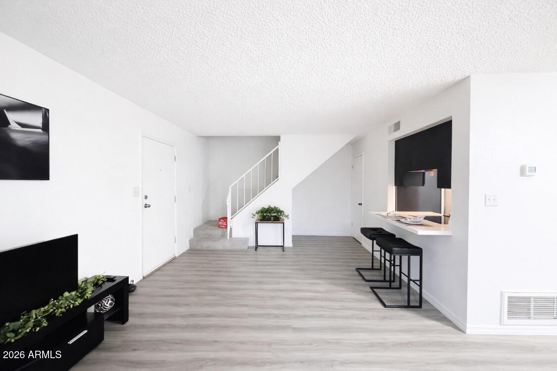 3221 West Royal Palm Road Phoenix, AZ 85051 - Photo 3 of 23 a view of a livingroom with furniture and wooden floor