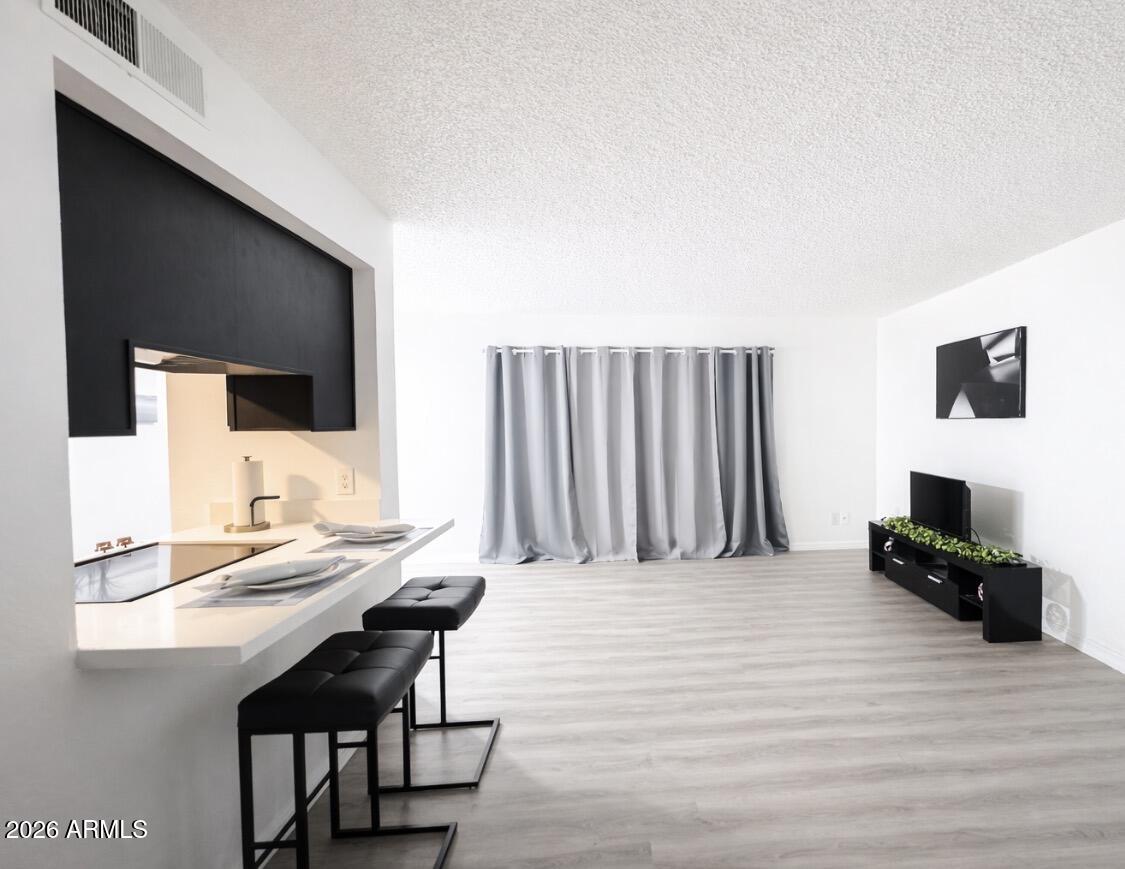 3221 West Royal Palm Road Phoenix, AZ 85051 - Photo 4 of 23 a living room with furniture and a flat screen tv