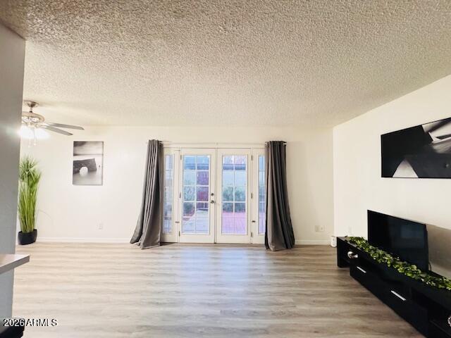 3221 West Royal Palm Road Phoenix, AZ 85051 - Photo 5 of 23 a view of a livingroom with wooden floor and a flat screen tv