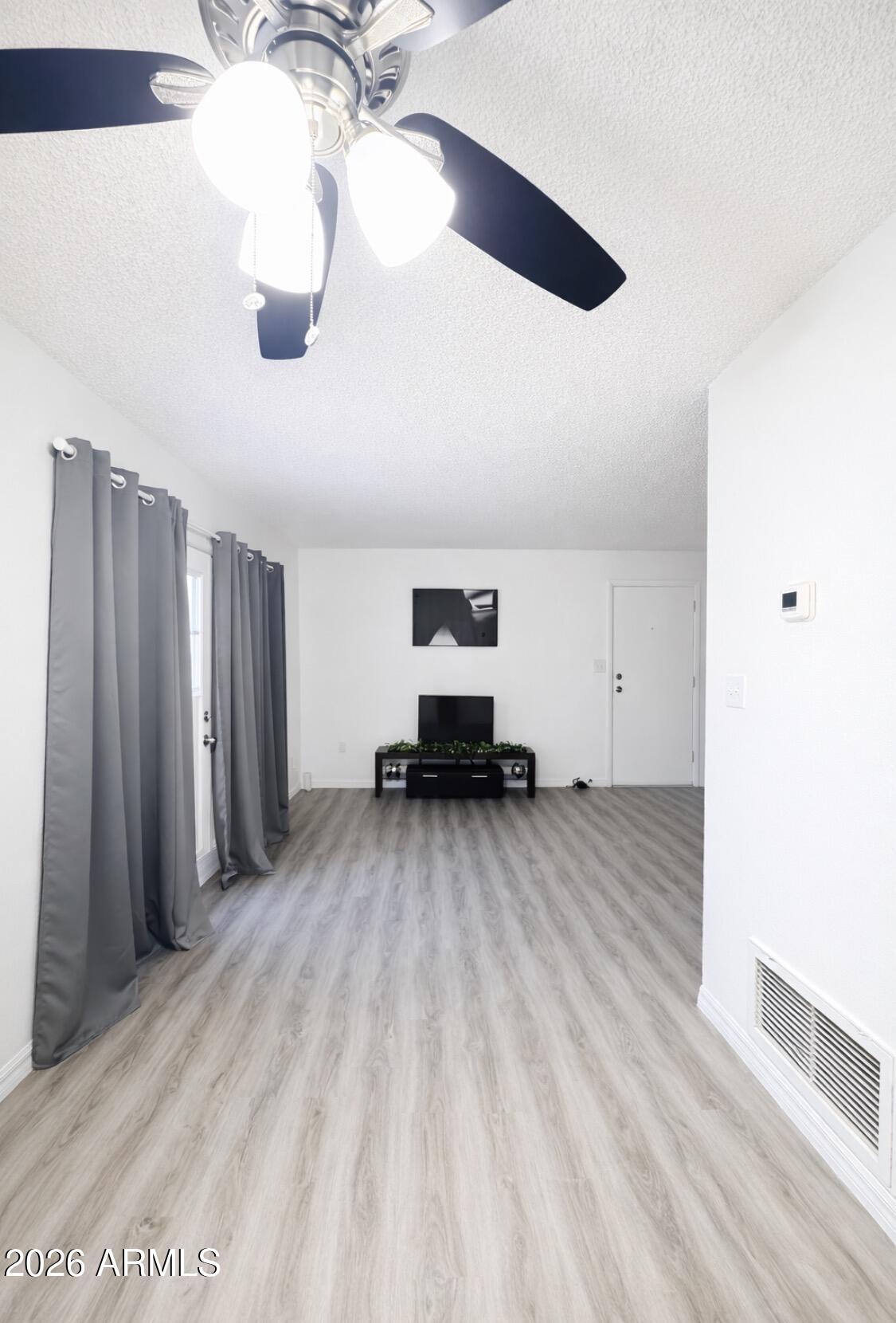 3221 West Royal Palm Road Phoenix, AZ 85051 - Photo 8 of 23 a view of a room with wooden floor