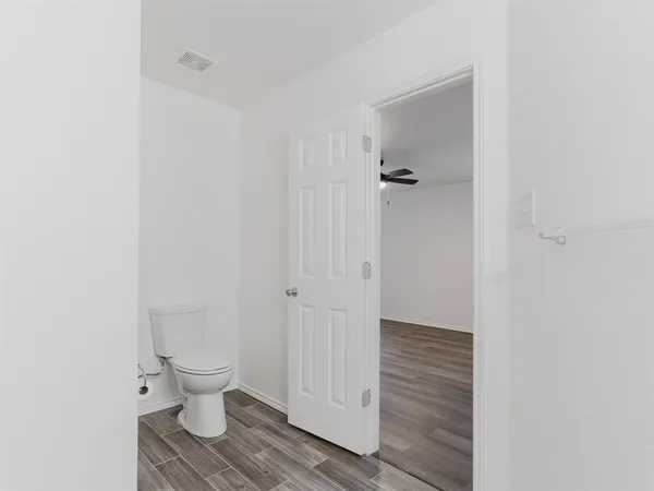 a bathroom view of a toilet and a shower