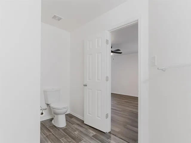 a bathroom view of a toilet and a shower