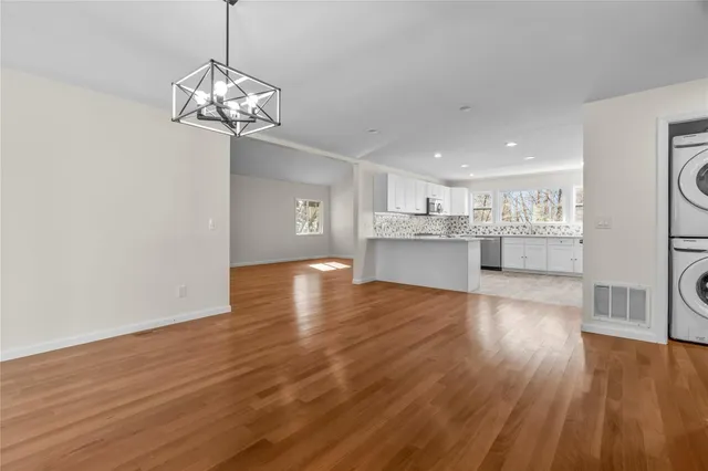 a view of a kitchen with stove and wooden floor