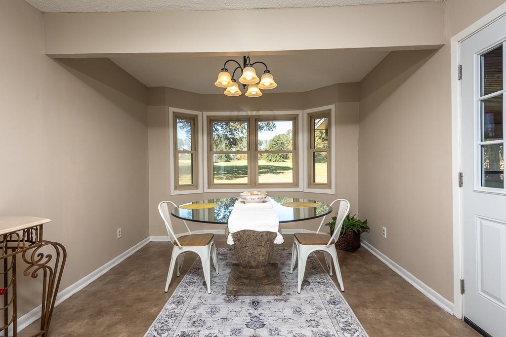 5750 Brighton-Clopton Road Brighton, TN 38011 - Photo 14 of 26 a dining room with furniture a rug and a window