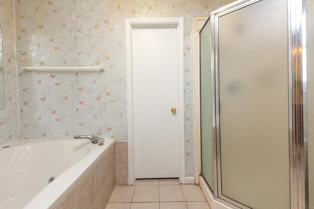 5750 Brighton-Clopton Road Brighton, TN 38011 - Photo 22 of 26 a bathroom with a bathtub and a shower
