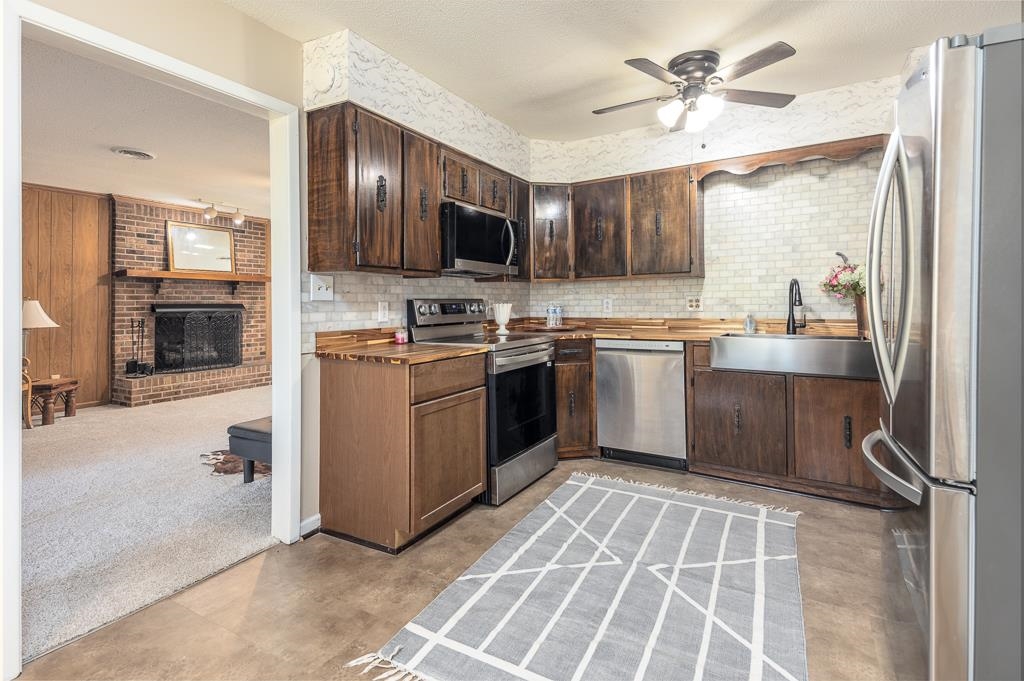 5750 Brighton-Clopton Road Brighton, TN 38011 - Photo 8 of 26 a kitchen with stainless steel appliances granite countertop a sink stove and refrigerator