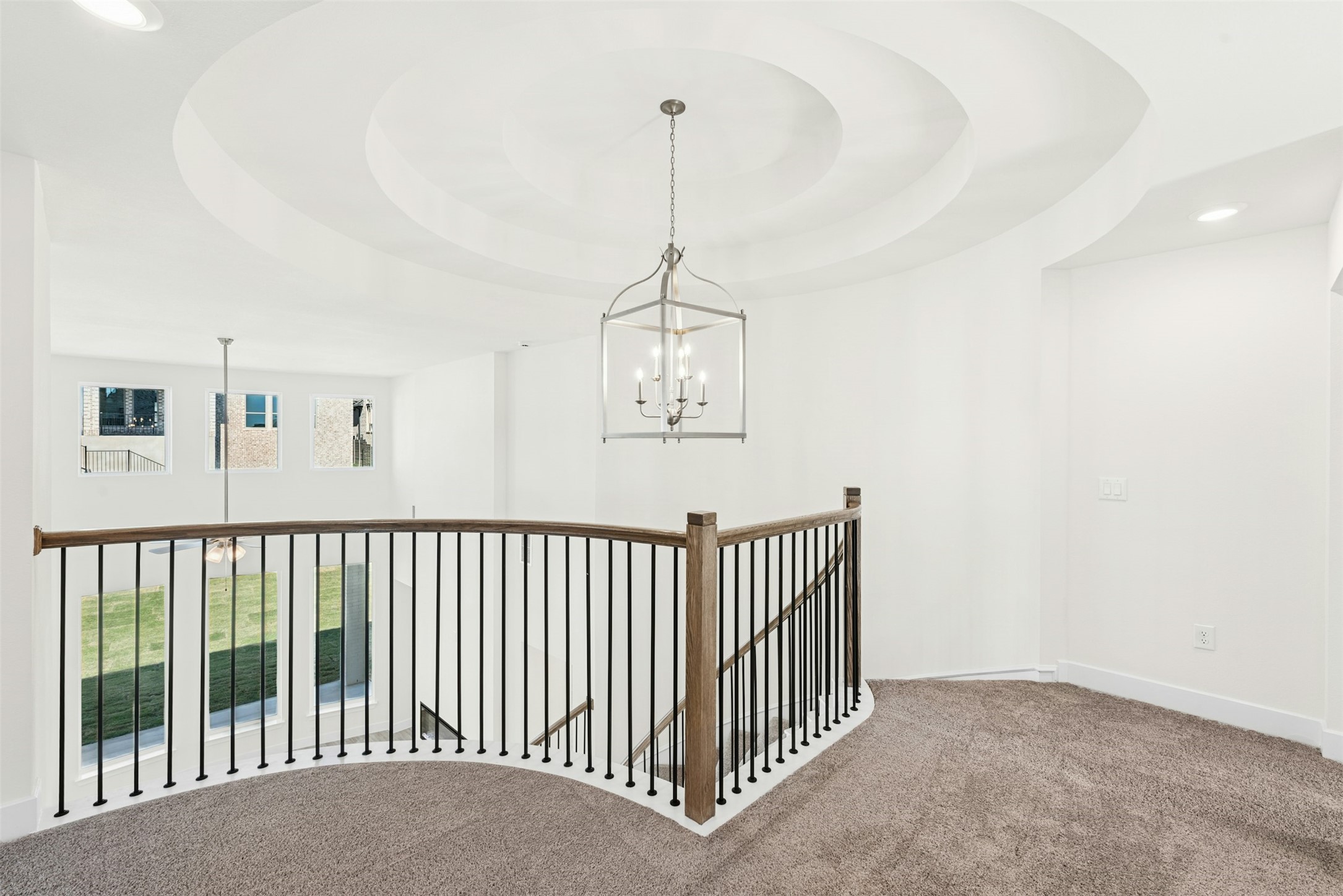 1520 Rodeo Ridge Drive Georgetown, TX 78628 - Photo 13 of 29 Corridor with a tray ceiling, recessed lighting, an upstairs landing, carpet, and a chandelier