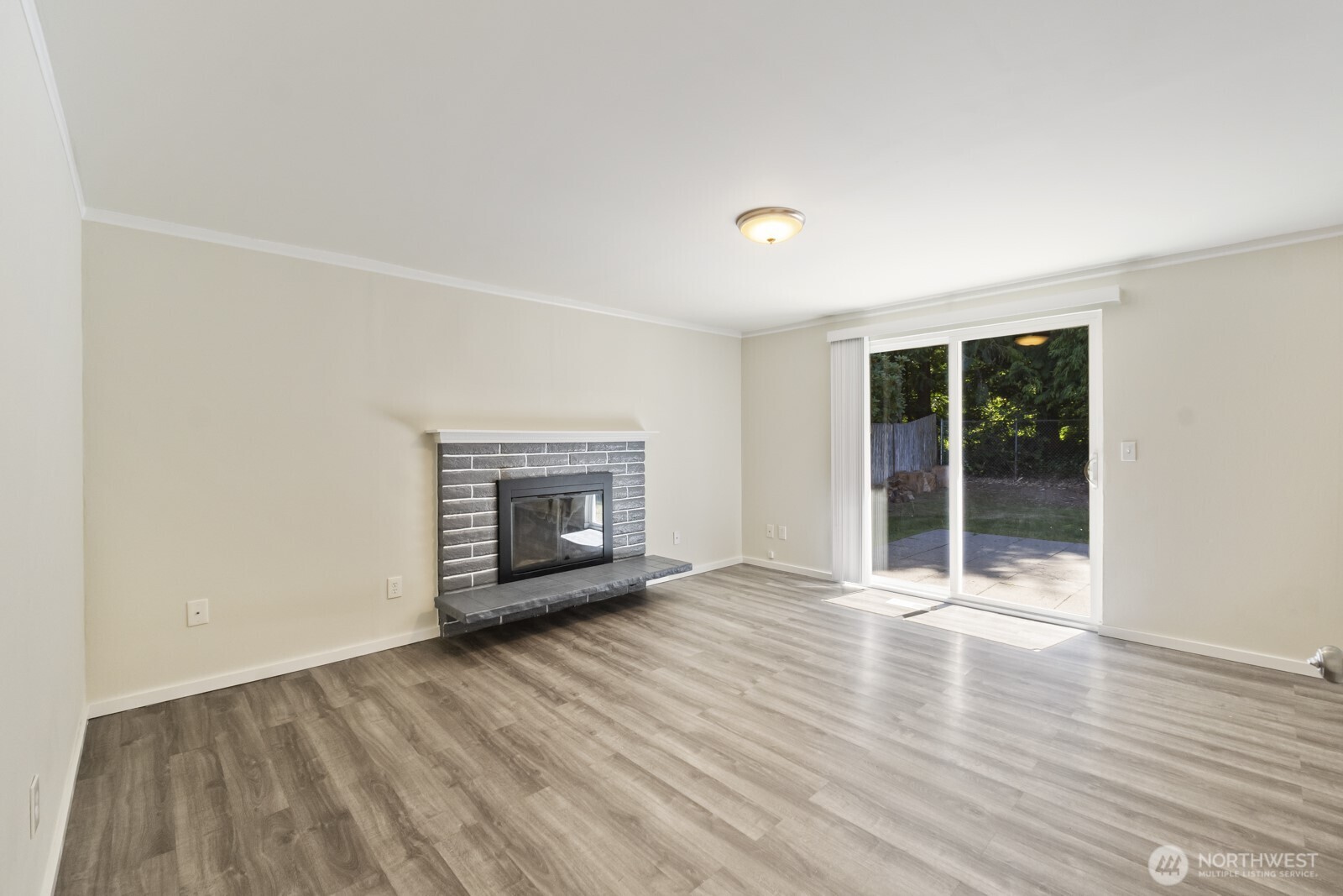 210 219th Place Southwest Bothell, WA 98021 - Photo 11 of 31 an empty room with wooden floor and fireplace