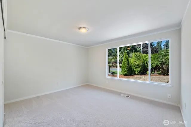 an empty room with large windows