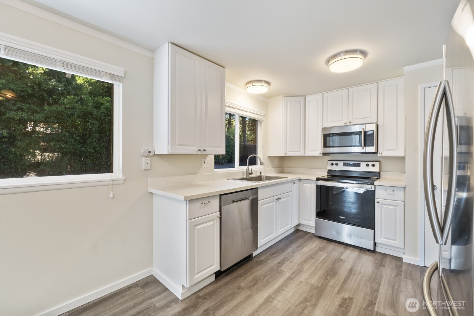 210 219th Place Southwest Bothell, WA 98021 - Photo 2 of 31 a kitchen with a stove a sink and a microwave