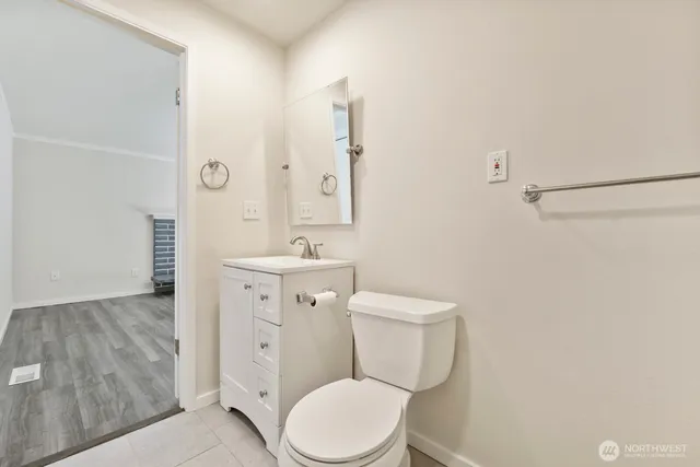 a white toilet sitting next to a bathroom sink
