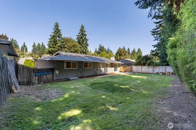 a view of a house with backyard and sitting area