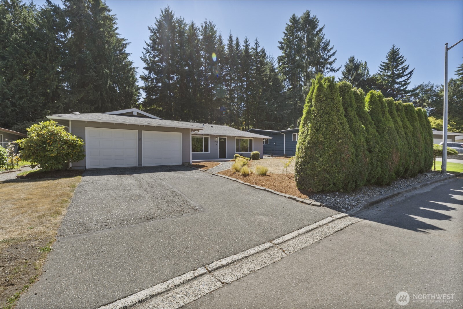 210 219th Place Southwest Bothell, WA 98021 - Photo 30 of 31 a view of a house with a yard and trees