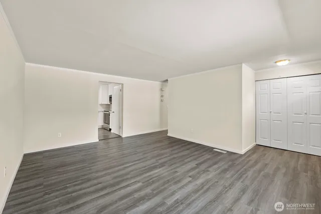 a view of an empty room with wooden floor