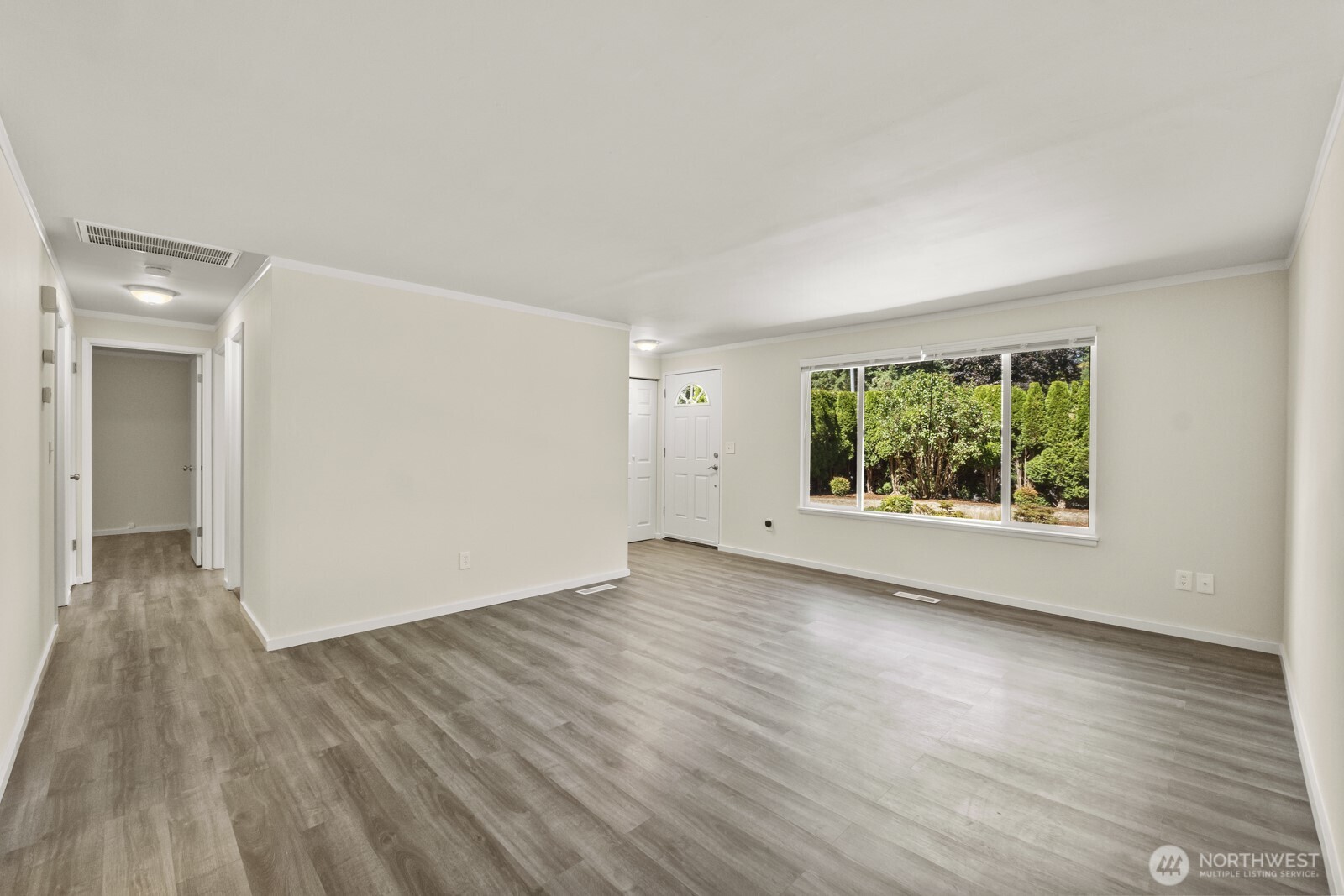 210 219th Place Southwest Bothell, WA 98021 - Photo 6 of 31 a view of a big room with wooden floor and windows